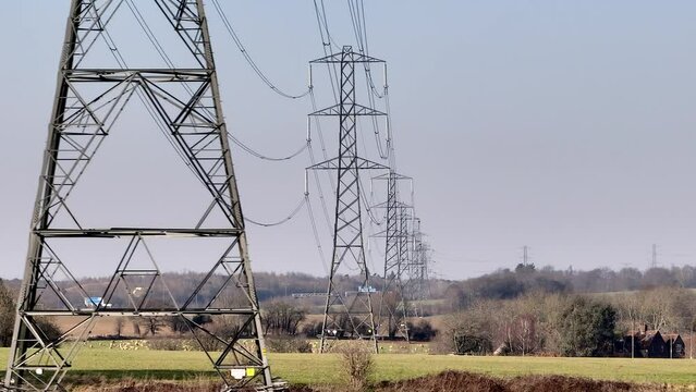 Rows of High Voltage Lattice Power Line Towers Aerial View