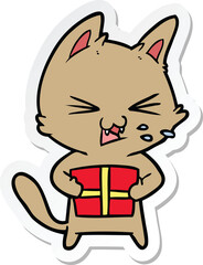 sticker of a cartoon hissing cat with christmas present