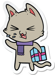 sticker of a cartoon hissing cat with christmas present