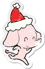 cute distressed sticker cartoon of a elephant wearing santa hat