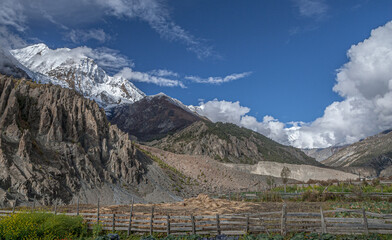View of the high altitude plateau with  Annapurna range in clouds (in the background) on the approach to Manang village, Manang district, Around Annapurna trek, Nepal Himalayas, Nepal