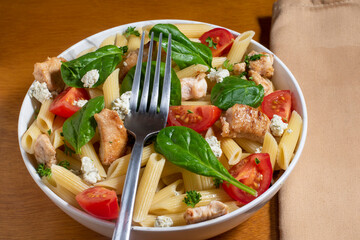 penne pasta salad top with chicken and goat cheese