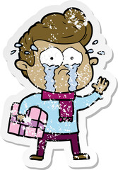 distressed sticker of a cartoon crying man with present