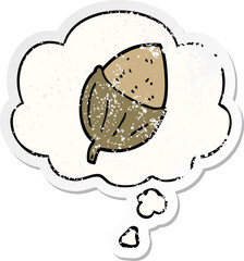cartoon acorn and thought bubble as a distressed worn sticker