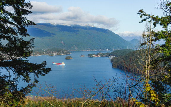 Oil tanker moored in tranquil, pristine waters of Burrard Inlet, during winter, as viewed from Burnaby Mountain Park, BC.