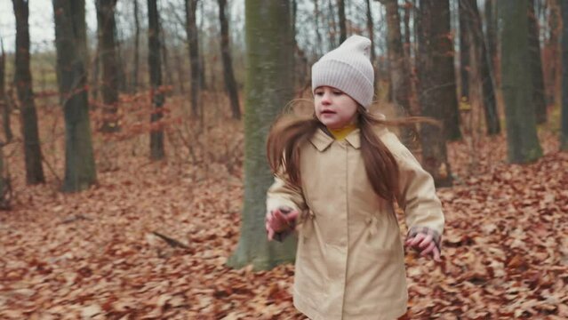 little girl running in the autumn forest