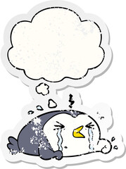 cartoon crying penguin and thought bubble as a distressed worn sticker