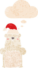 cartoon bear wearing christmas hat and thought bubble in retro textured style