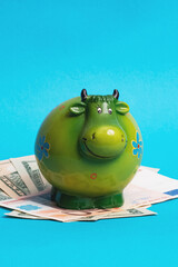 Cow money box cow on the spread out money