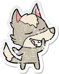 distressed sticker of a cartoon wolf laughing