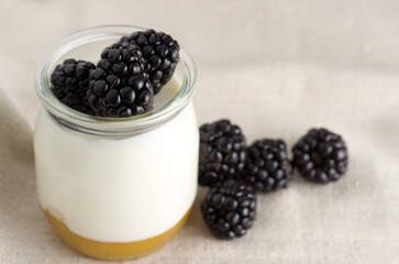 Macro Image of Nature Yogurt in Glass Jar with Blackberries