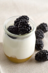 Macro Image of Nature Yogurt in Glass Jar with Blackberries