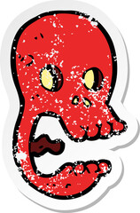 retro distressed sticker of a funny cartoon skull