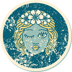 distressed sticker tattoo style icon of a maidens face winking