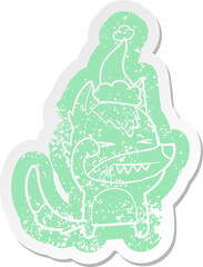 tired wolf cartoon distressed sticker of a wearing santa hat