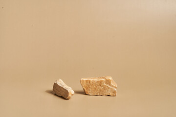 Layout for exhibitions, presentations of your products. With space to copy. Podium made of natural stone on a pastel beige background. High quality photo