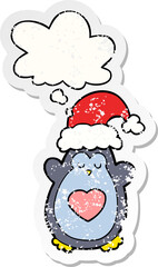 cute christmas penguin and thought bubble as a distressed worn sticker