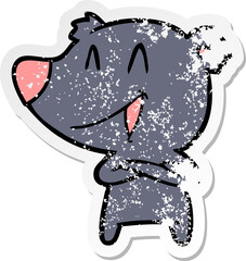 distressed sticker of a laughing bear with crossed arms cartoon
