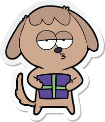 sticker of a cartoon bored dog with christmas present
