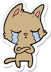 sticker of a crying cartoon cat with folded arms