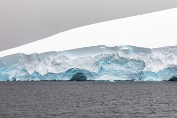 Wind Cave Eroded into a Floating Iceberg in The Remote Polar Gullet area near Adelaide Island, Antarctica