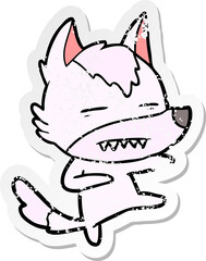 distressed sticker of a cartoon wolf kicking
