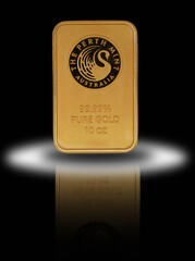 10 oz pure Gold 99.99 bar on reflective surface