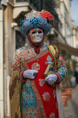 Fototapeta na wymiar VENICE - FEBRUARY 11: A person in Venetian costume attends the Carnival of Venice, a festival starting two weeks before Ash Wednesday in Venice, Italy.