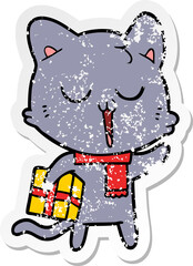 distressed sticker of a cartoon cat with gift