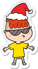 sticker cartoon of a boy wearing sunglasses wearing santa hat
