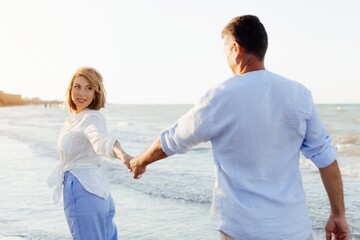 Happy romantic middle aged couple are by the sea. Lifestyle Concept. Closeup photo.