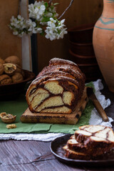 Traditional Easter bread with chocolate and nut filling on a wooden background.