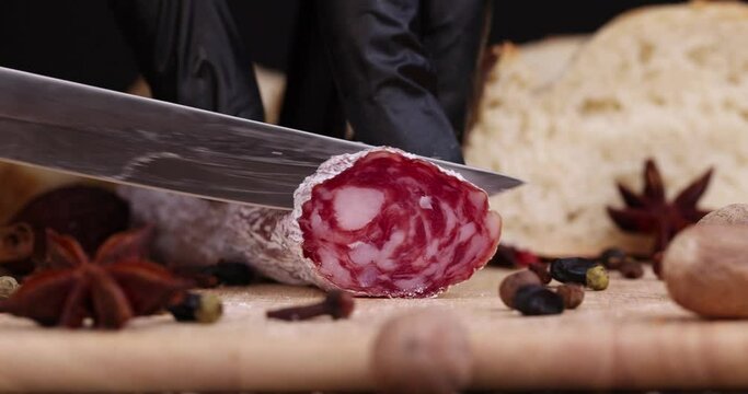 Slicing pork sausage with white mold , dried meat with spices and in white mold close - up