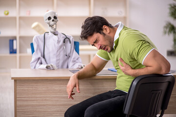 Obraz premium Young male patient visiting skeleton doctor