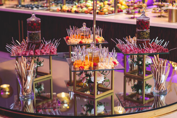 Beautifully decorated banquet catering table with variety of different food snacks, sandwiches, croissants and appetizers on a party event or celebration, delicatessen setting, coffee break