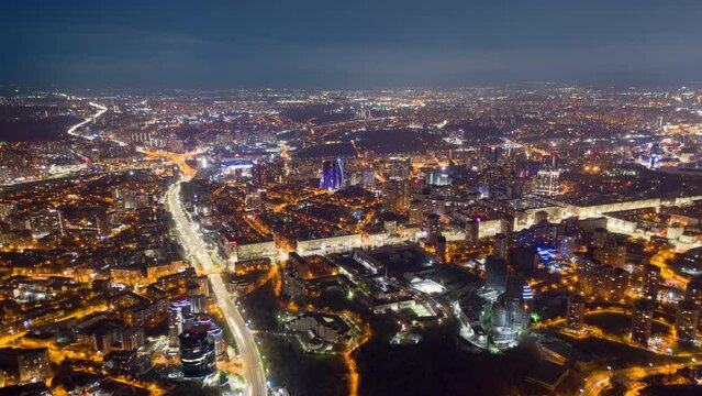 Drone footage of the metropolis, vividly illuminated at night. Jaw-dropping scenery of the picturesque urban panorama as seen from above. High quality 4k footage