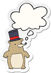 cartoon bear in top hat and thought bubble as a printed sticker