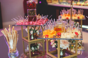 Beautifully decorated banquet catering table with variety of different food snacks, sandwiches, croissants and appetizers on a party event or celebration, delicatessen setting, coffee break