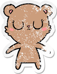 distressed sticker of a peaceful cartoon bear cub
