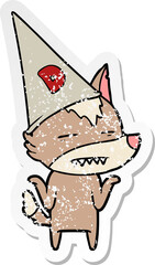 distressed sticker of a cartoon wolf wearing dunce hat