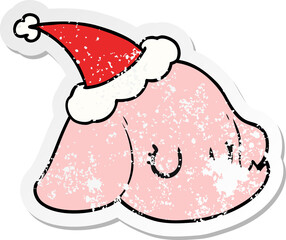 distressed sticker cartoon of a elephant face wearing santa hat