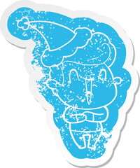 excited man cartoon distressed sticker of a wearing santa hat