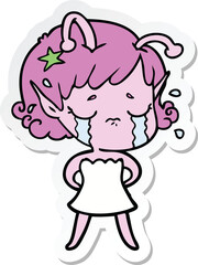 sticker of a cartoon crying alien girl