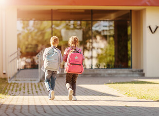 Fototapeta Girl and boy walking school together to study at it. obraz