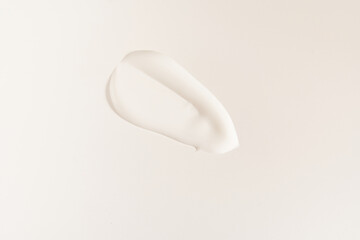 A smear of cosmetic cream. A white creamy drop of skin care cream. Fresh, smooth brushstroke isolated on a white background with space to copy. High quality photo