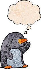 cartoon penguin and thought bubble in grunge texture pattern style