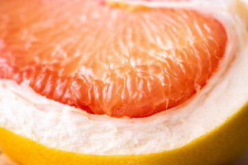 Pomelo on a white background.Advertising pomelo.Grapefruit.Pomelo pink. Fruit isolated.Cut pomelo on white background.Pomelo macro shot.Grapefruit macro shot.Juice drops on the fruit. fruit macro shot