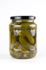 Pickled cucumbers in a glass jar. Preserved pickled gherkins on white background. 