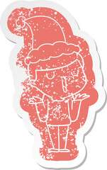 cartoon distressed sticker of a happy boy with no worries wearing santa hat