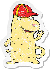 retro distressed sticker of a cartoon dog wearing cap